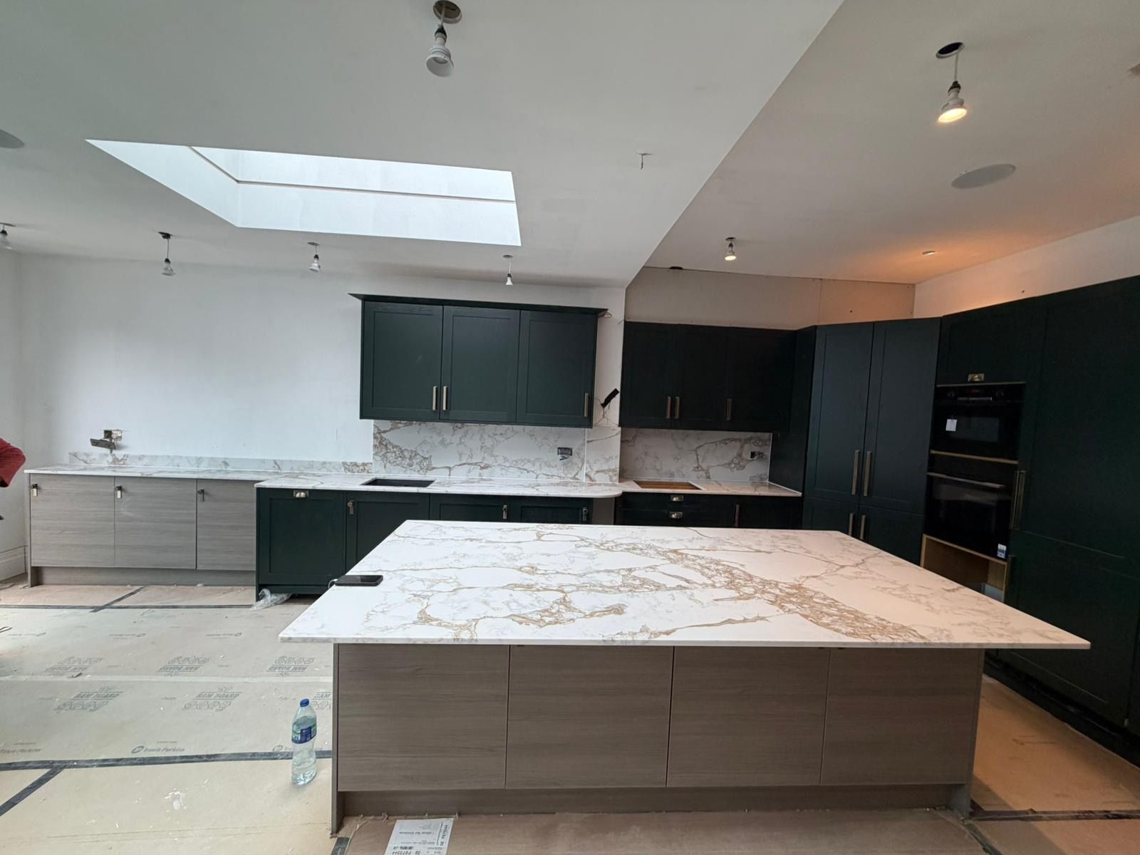 Dark green kitchen with Calacatta marble island